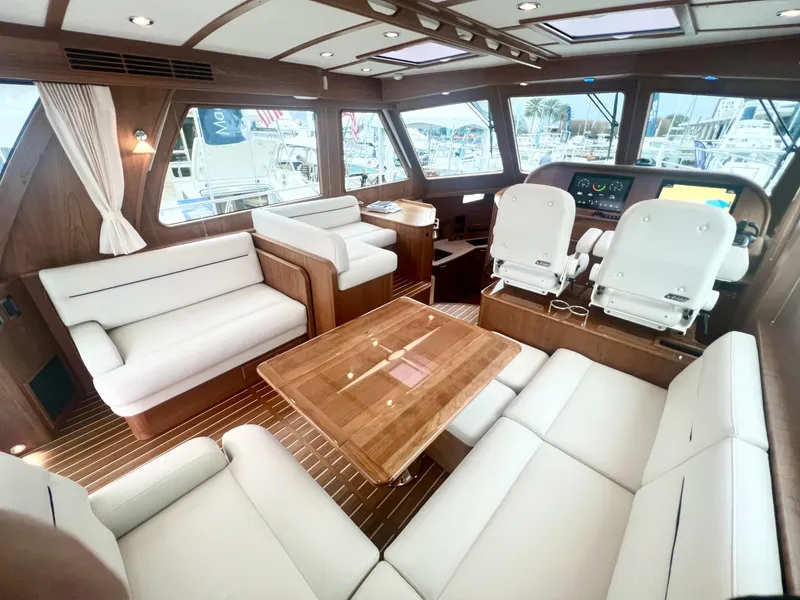 Slide: The Image of Luxurious interior of 2025 Sabre 48 Salon Express yacht with white seating and wooden accents. - 9