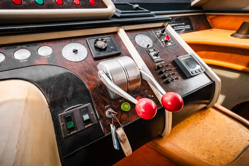 Slide: The Image of Control panel of a 1992 Monte Fino 94 Motor Yacht with throttle levers and gauges. - 10
