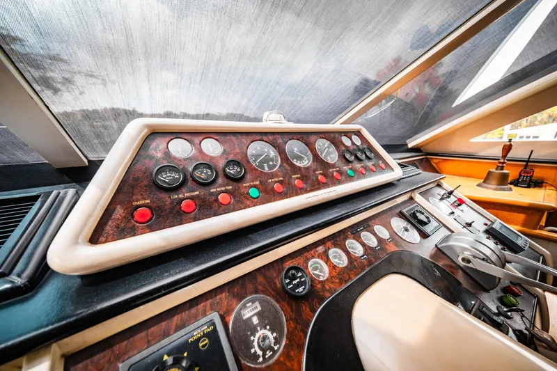 Slide: The Image of Control panel of a 1992 Monte Fino 94 Motor Yacht with various gauges and switches. - 11