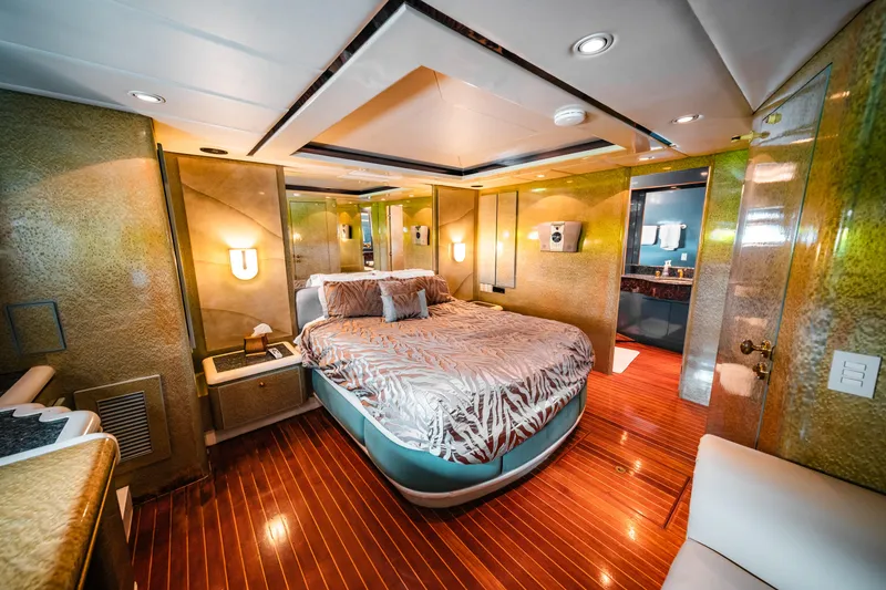 Slide: The Image of Luxurious master bedroom on a 1992 Monte Fino 94 Motor Yacht with elegant wood flooring. - 12