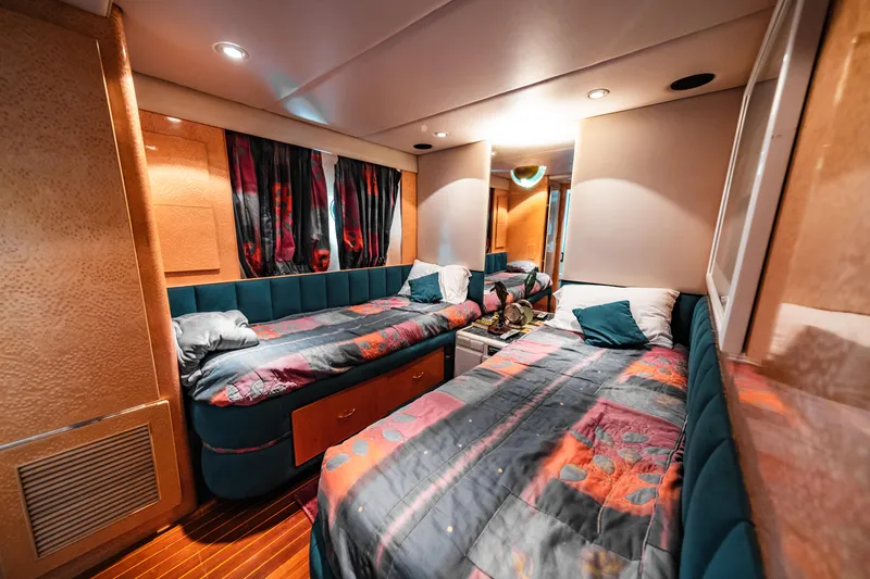 Slide: The Image of Cozy twin bedroom in 1992 Monte Fino 94 Motor Yacht with vibrant decor. - 14