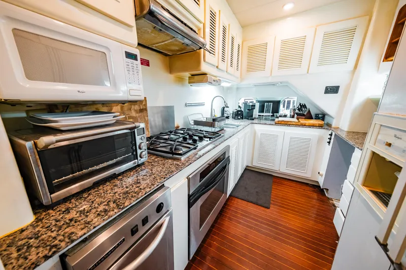 Slide: The Image of Modern kitchen in a 1992 Monte Fino 94 Motor Yacht with granite countertops and stainless steel appliances. - 22