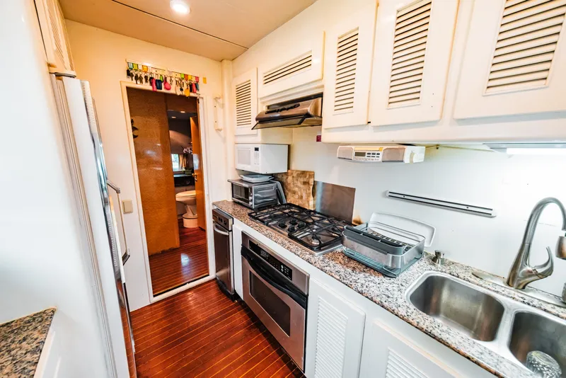Slide: The Image of 1992 Monte Fino 94 Motor Yacht kitchen with modern appliances and granite countertops. - 23