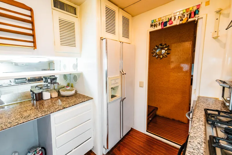 Slide: The Image of 1992 Monte Fino 94 Motor Yacht kitchen with granite countertops and modern appliances. - 24