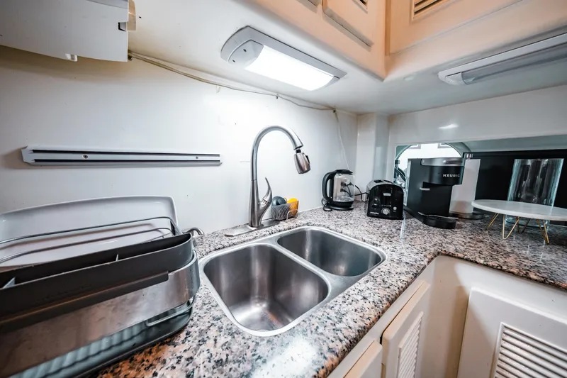 Slide: The Image of Modern kitchen area in a 1992 Monte Fino 94 Motor Yacht with granite countertops. - 27