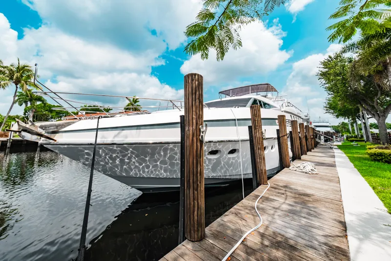 Slide: The Image of 1992 Monte Fino 94 Motor Yacht docked by a wooden pier on a sunny day. - 3