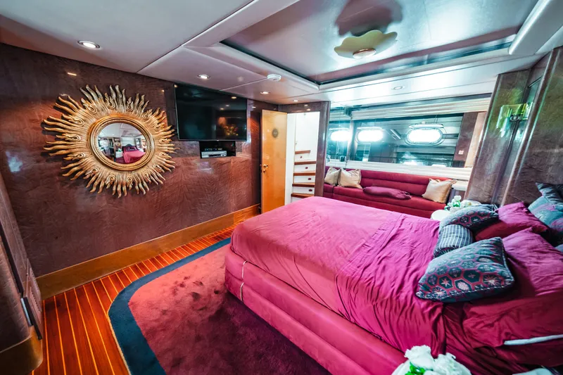Slide: The Image of Luxurious bedroom interior of 1992 Monte Fino 94 Motor Yacht with plush red bedding. - 44