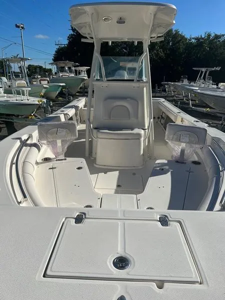 Slide: The Image of 2023 Sea Born LX24 Center Console LE boat, front view at marina. - 5