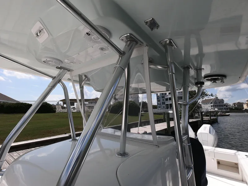 Slide: The Image of 2003 Venture 34 Open boat with stainless steel T-top and waterfront view. - 10