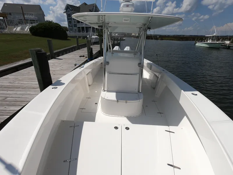 Slide: The Image of 2003 Venture 34 Open boat docked, showcasing spacious deck and center console. - 11