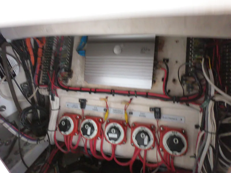 Slide: The Image of Electrical panel of a 2003 Venture 34 Open boat with wiring and switches. - 13