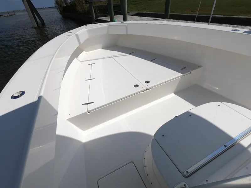 Slide: The Image of 2003 Venture 34 Open boat interior with white seating and storage compartments. - 16