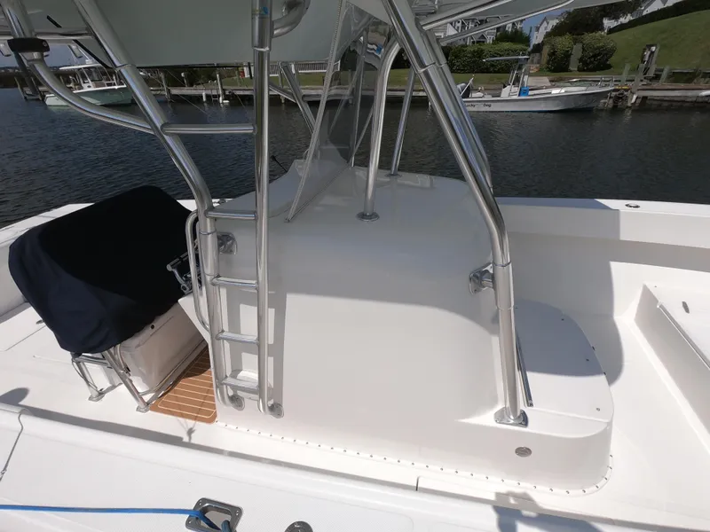 Slide: The Image of 2003 Venture 34 Open boat with ladder and seating, docked by the water. - 4