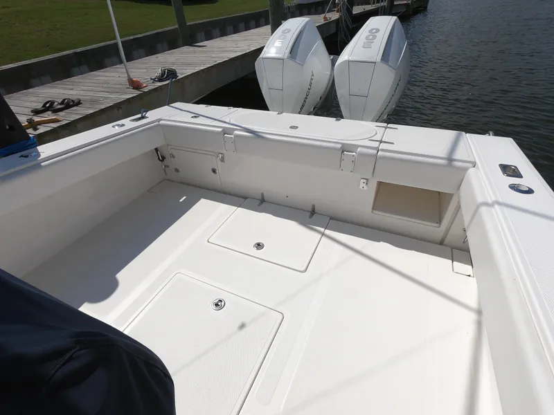 Slide: The Image of 2003 Venture 34 Open boat deck with twin outboard engines at dock. - 6