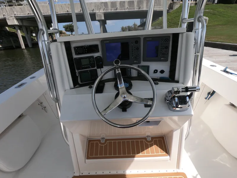 Slide: The Image of 2003 Venture 34 Open boat helm with steering wheel and navigation controls. - 9