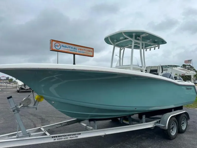 Slide: The Image of 2023 Tidewater 220 CC Adventure boat on trailer at Nautical Ventures. - 2