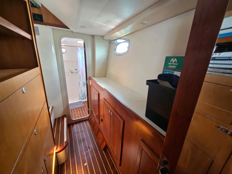 Slide: The Image of Interior of 2009 Fusion 40 yacht with wooden cabinetry and flooring. - 11