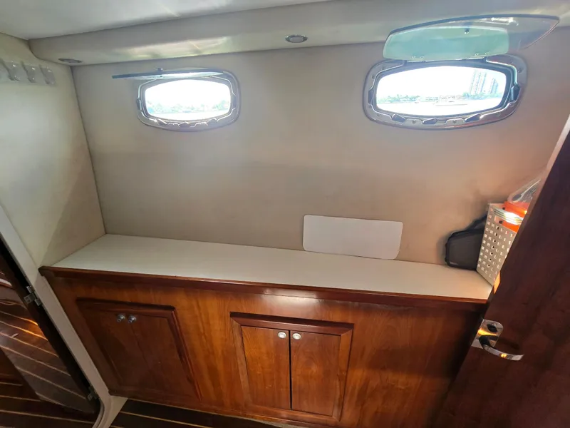Slide: The Image of Interior of 2009 Fusion 40 boat with wooden cabinets and porthole windows. - 12