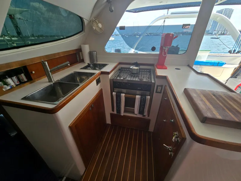 Slide: The Image of Luxurious 2009 Fusion 40 yacht kitchen with ocean view, featuring modern appliances and wood accents. - 14