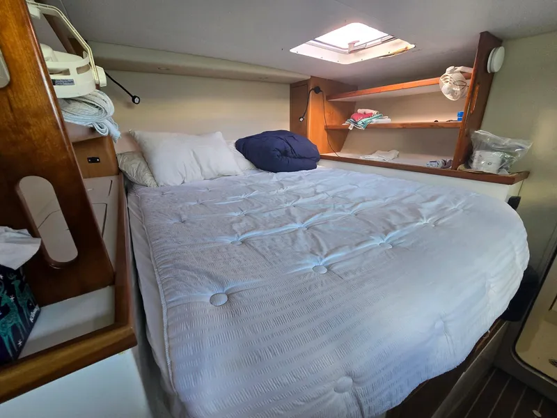 Slide: The Image of Cozy cabin bedroom in 2009 Fusion 40 yacht with skylight and wooden shelves. - 16