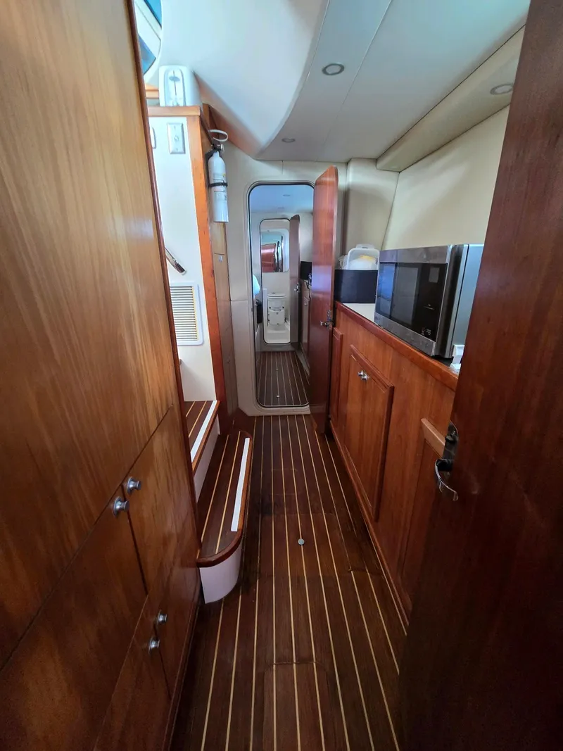 Slide: The Image of Interior of 2009 Fusion 40 yacht with wooden cabinetry and striped flooring. - 19