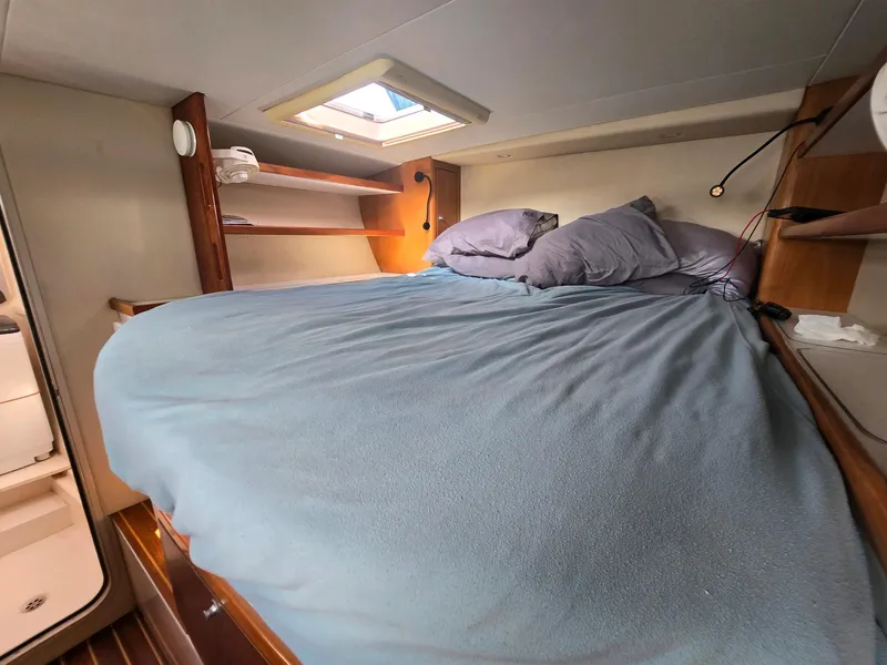 Slide: The Image of Cozy cabin interior of 2009 Fusion 40 yacht with skylight and bedding. - 21
