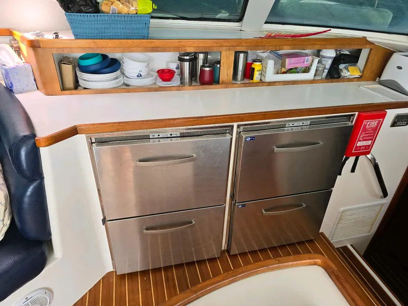 Slide: The Image of 2009 Fusion 40 yacht kitchen with stainless steel appliances and wooden accents. - 23