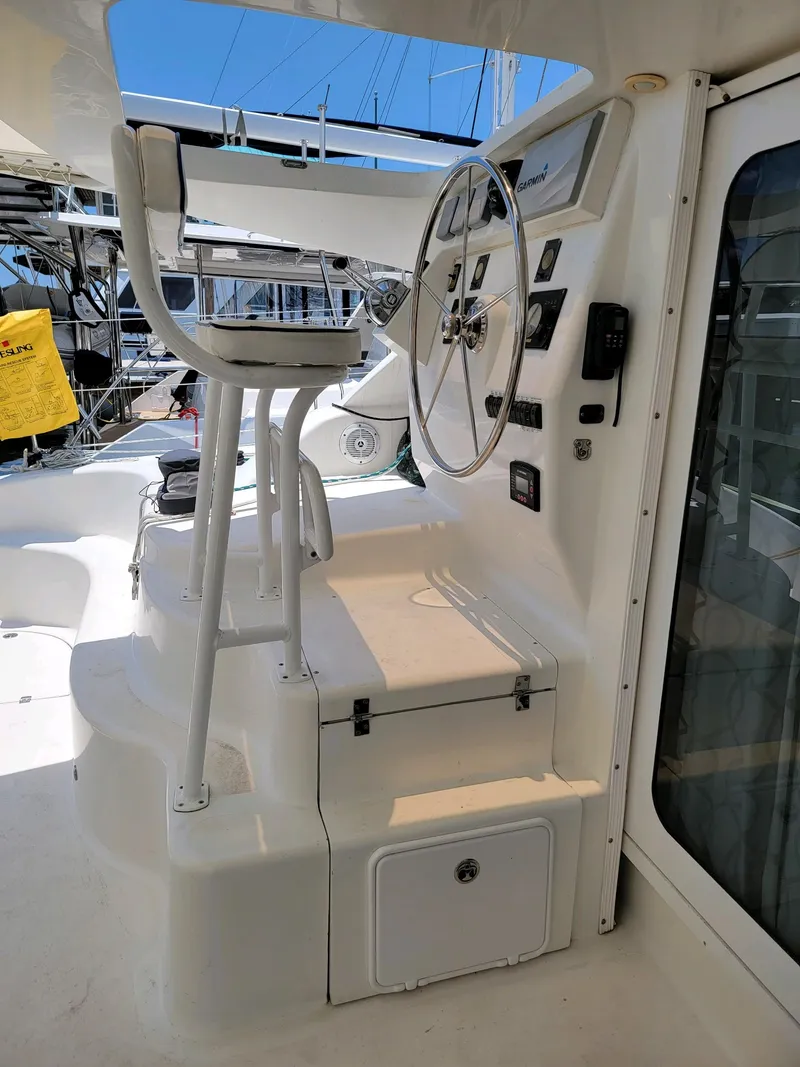 Slide: The Image of 2009 Fusion 40 yacht helm station with steering wheel and controls. - 25
