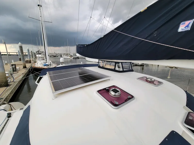 Slide: The Image of 2009 Fusion 40 sailboat with solar panel, docked at marina under cloudy sky. - 28