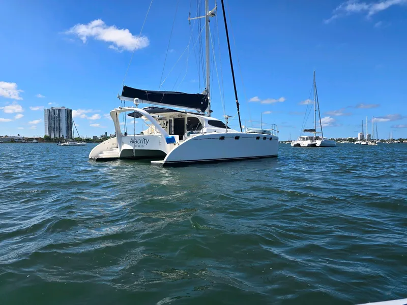 Slide: The Image of Sailing catamaran Fusion 40, 2009 model, anchored in a sunny marina. - 3
