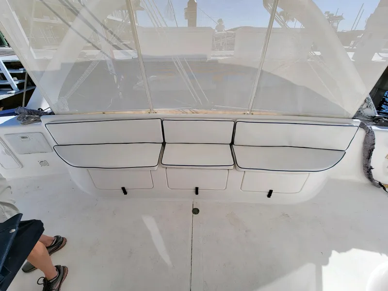 Slide: The Image of 2009 Fusion 40 boat interior with white cushioned seating and storage compartments. - 32