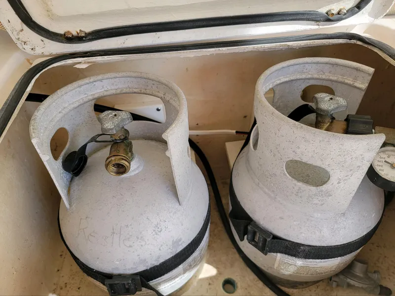 Slide: The Image of Two propane tanks secured in a storage compartment of a 2009 Fusion 40. - 33