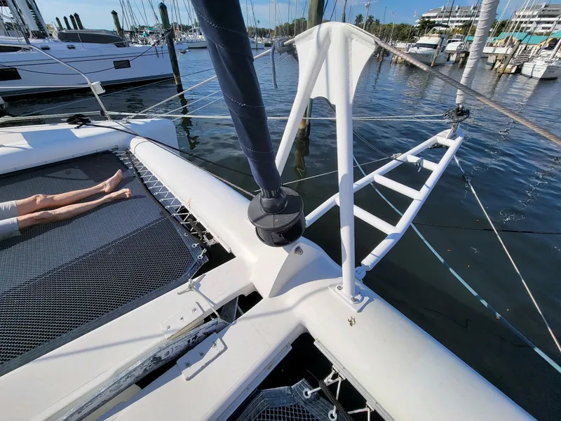 Slide: The Image of 2009 Fusion 40 catamaran docked at marina, featuring netted deck and visible rigging. - 35