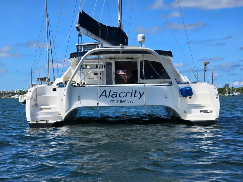 Slide: The Image of Fusion 40 catamaran, 2009 model, named Alacrity, docked in calm waters. - 7