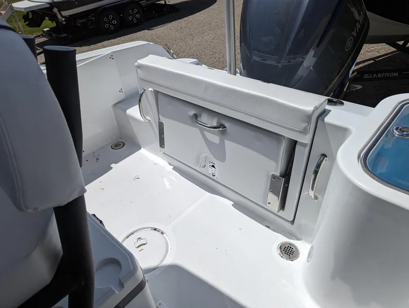 Slide: The Image of 2024 Wellcraft 223 Fisherman boat interior with storage compartment and seating. - 12