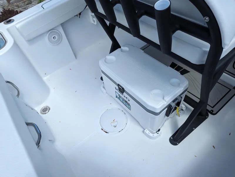 Slide: The Image of 2024 Wellcraft 223 Fisherman boat interior with cooler and rod holders. - 13