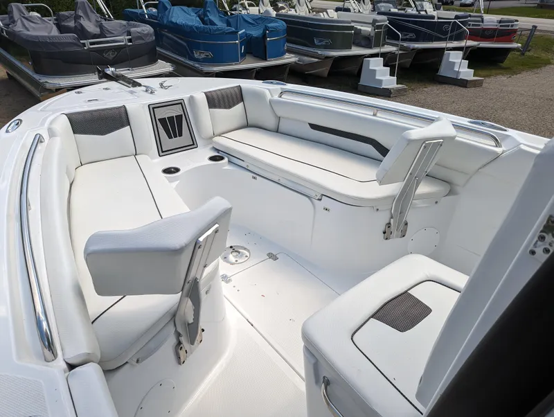 Slide: The Image of 2024 Wellcraft 223 Fisherman boat interior with white cushioned seating. - 4