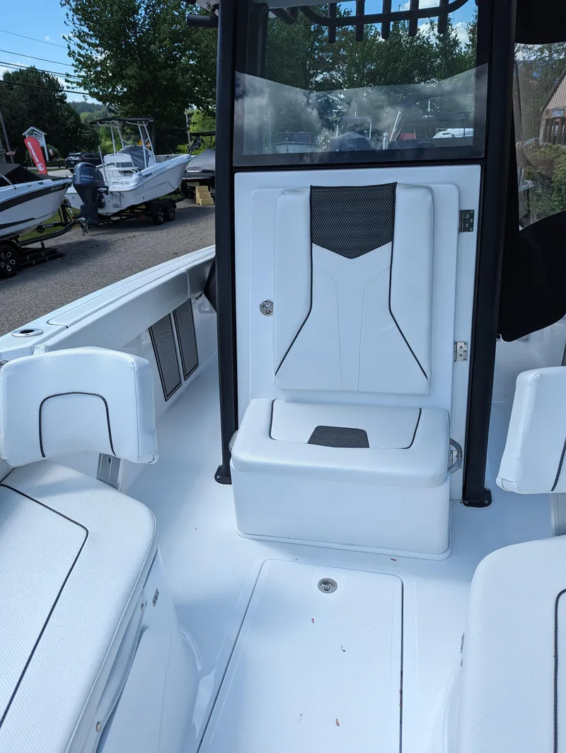 Slide: The Image of 2024 Wellcraft 223 Fisherman boat interior with seating and storage compartments. - 5