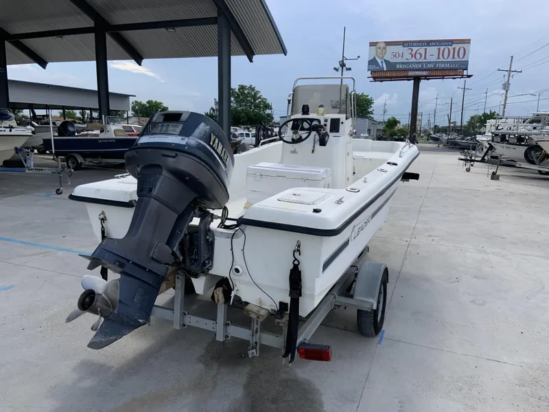 Slide: The Image of Leader 180 CAT 2000 model boat with outboard motor on trailer in marina. - 3