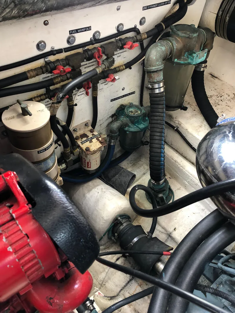 Slide: The Image of Engine compartment of a 1997 Tiara Yachts 3700 Open showing various mechanical components. - 12