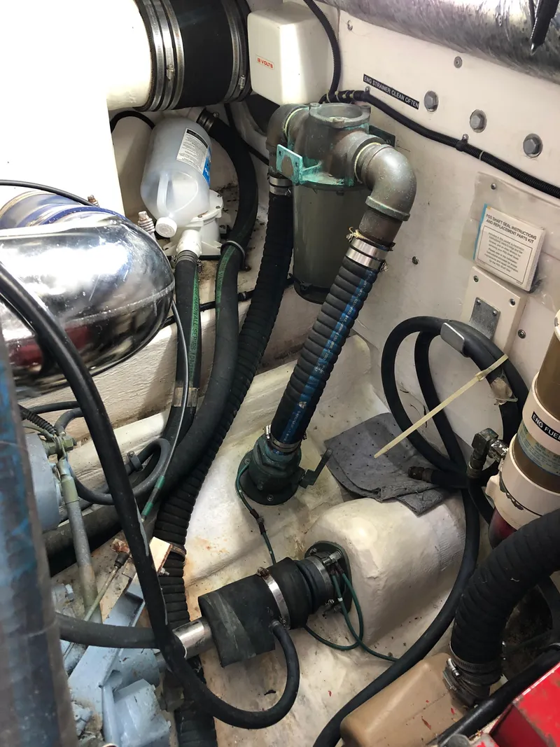 Slide: The Image of 1997 Tiara Yachts 3700 Open engine compartment with various hoses and components. - 13