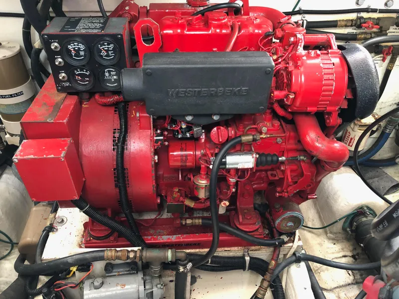 Slide: The Image of 1997 Tiara Yachts 3700 Open engine compartment with red Westerbeke generator. - 15