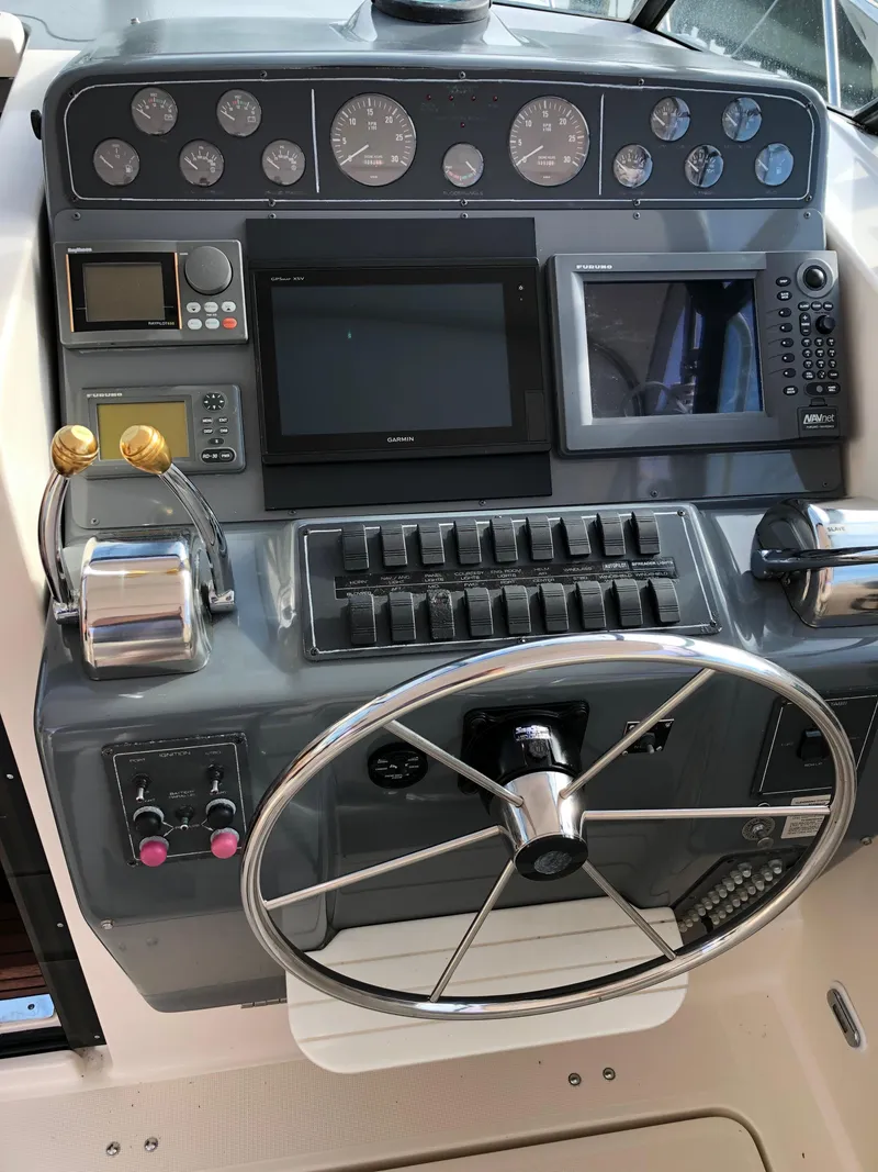 Slide: The Image of 1997 Tiara Yachts 3700 Open helm with navigation instruments and steering wheel. - 18