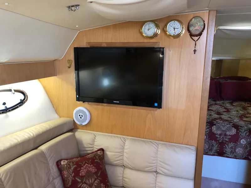 Slide: The Image of Interior of 1997 Tiara Yachts 3700 Open with TV, sofa, and bed. - 25