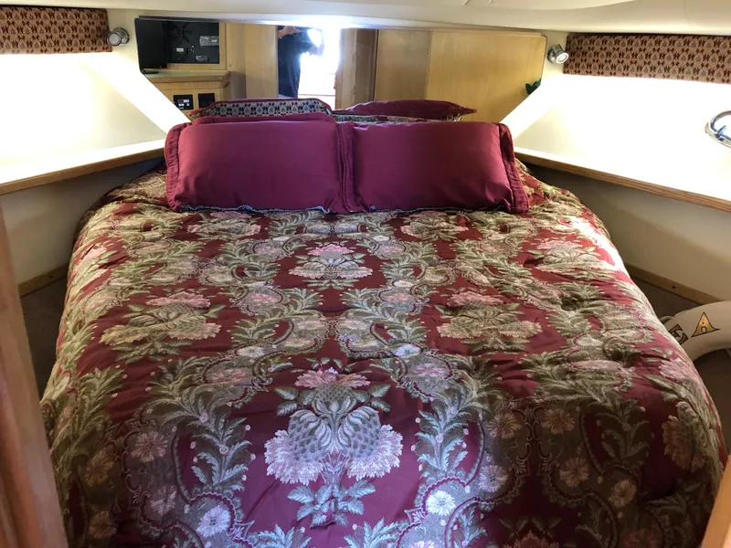 Slide: The Image of Luxurious bedroom in a 1997 Tiara Yachts 3700 Open with elegant bedding. - 26