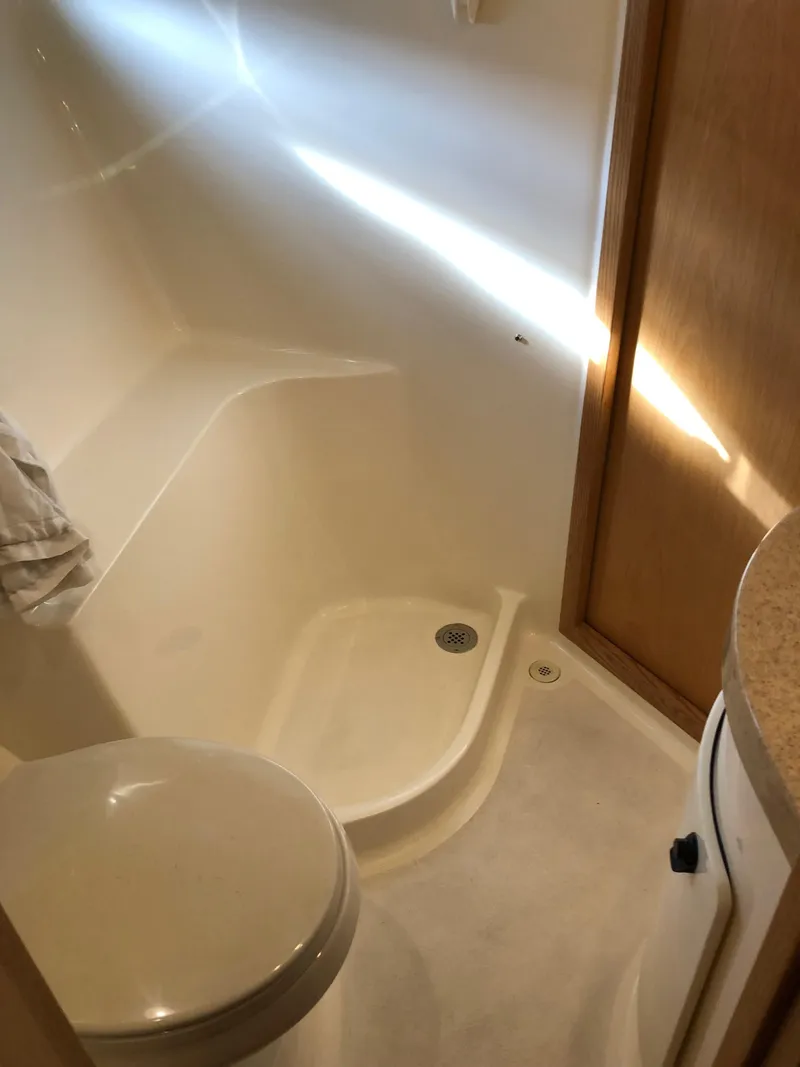 Slide: The Image of 1997 Tiara Yachts 3700 Open bathroom with shower and toilet. - 29