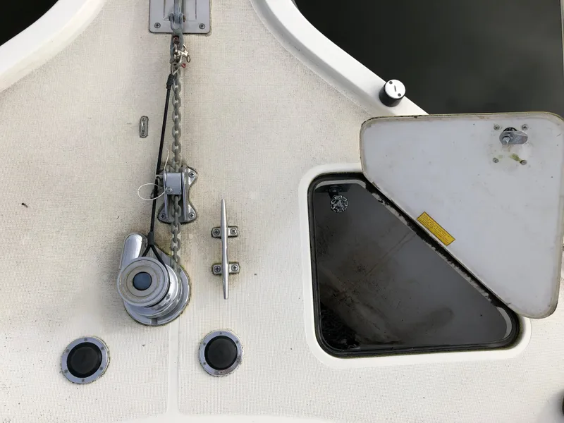 Slide: The Image of 1997 Tiara Yachts 3700 Open deck with anchor winch and storage compartment. - 3