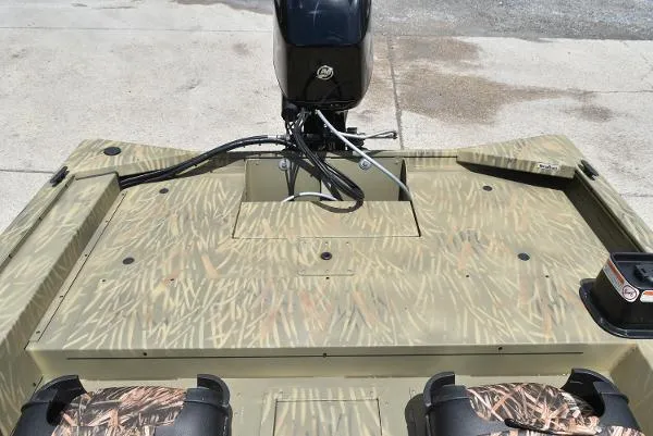 Slide: The Image of 2024 Tracker Grizzly 1754 SC boat with camouflage pattern and outboard motor. - 12