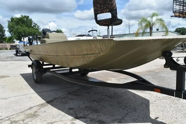 Slide: The Image of 2024 Tracker Grizzly 1754 SC boat on a trailer, parked outdoors. - 14