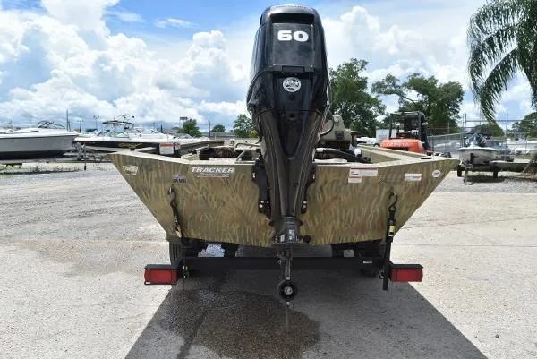 Slide: The Image of 2024 Tracker Grizzly 1754 SC boat with 60 HP engine, rear view. - 15